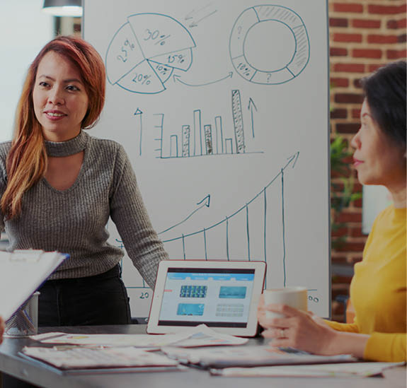 Diverse team of people meeting to discuss business growth, consultant presenting sales report and marketing statistics. Coworkers brainstorming ideas to plan company development.